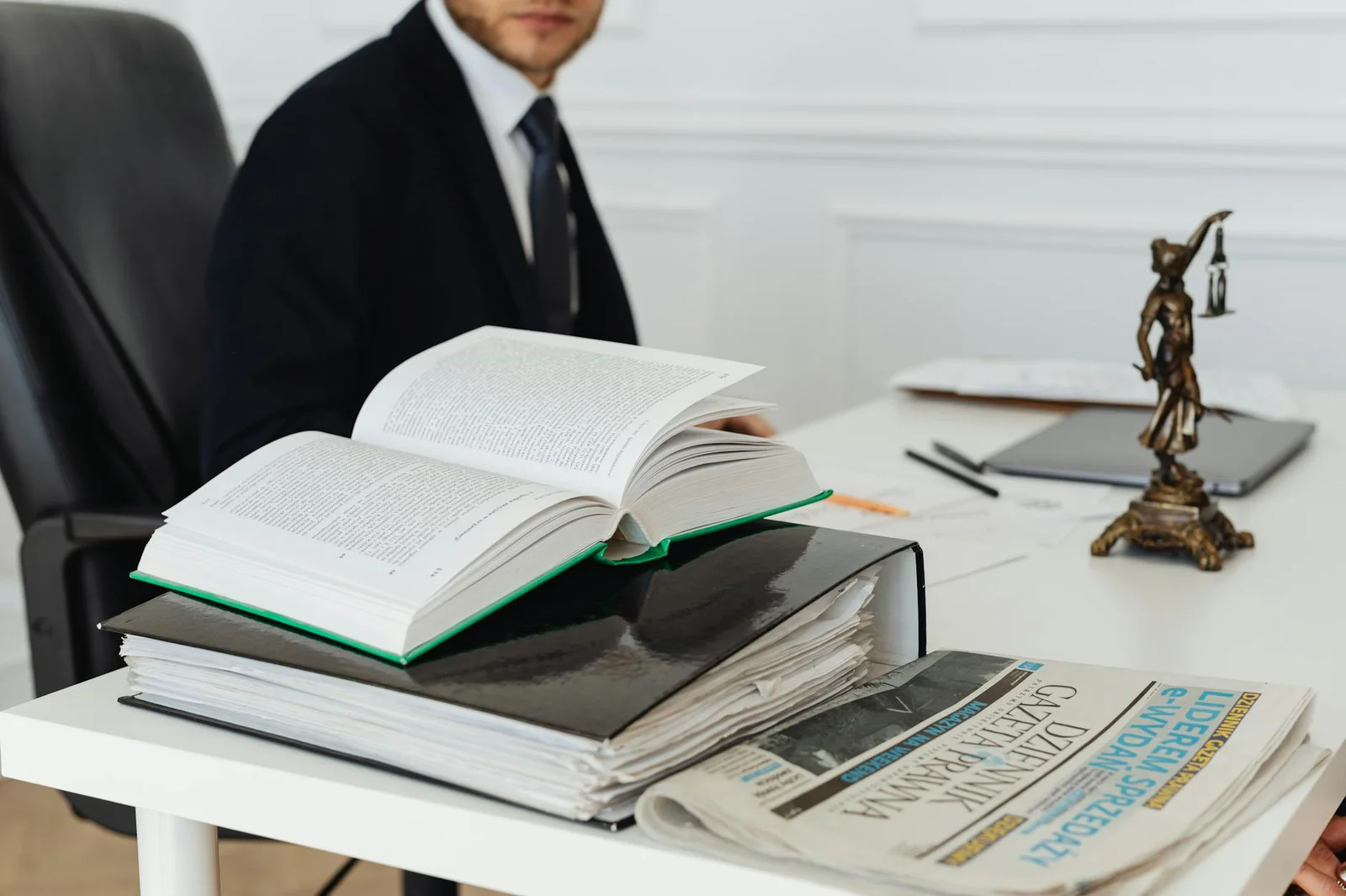 legal directory citations seo - Legal - A lawyer sitting at a desk with legal books, documents, and a newspaper, embodying pr