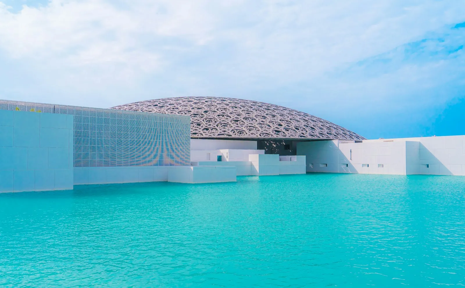 The domed roof of the Louvre Abu Dhabi over the water on Saadiyat Island