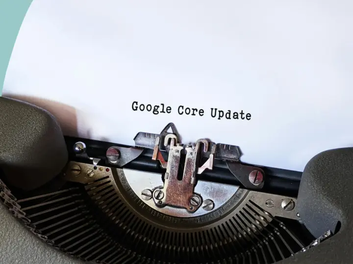 Close-up of a typewriter typing 'Google Core Update' on paper, symbolizing digital advancement.